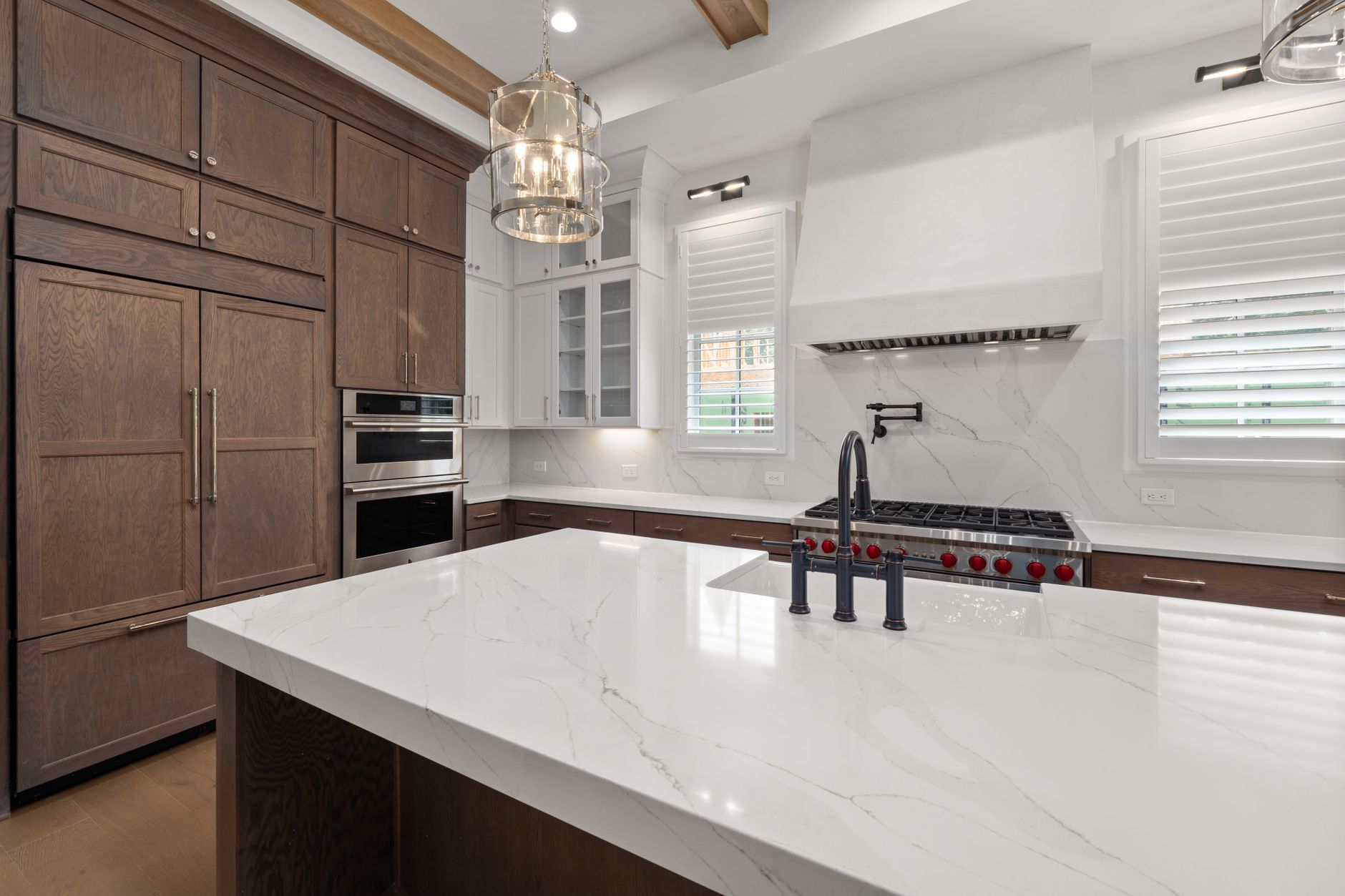 Elegant kitchen featuring a marble island, wooden cabinetry, and stainless steel appliances in Temecula, CA