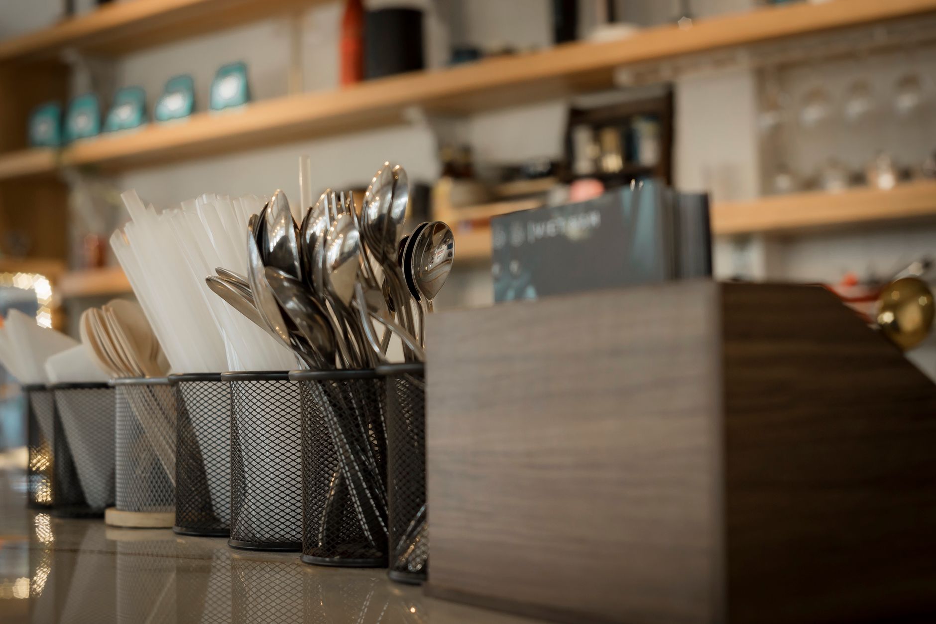 Close-up of neatly arranged utensils in a modern cafe setting with warm lighting in Temecula, CA